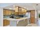 Well-lit kitchen featuring stainless steel appliances, a breakfast bar and light wood cabinetry at 2061 Misty Sunrise Trl, Sarasota, FL 34240