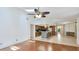 Open-concept living space with hardwood floors, ceiling fan, and bright kitchen with skylight at 2061 Misty Sunrise Trl, Sarasota, FL 34240
