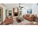 Elegant living room with a brick fireplace and natural light from windows at 2061 Misty Sunrise Trl, Sarasota, FL 34240