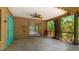 Relax on this covered patio with views of the lush backyard and screened-in pool at 2061 Misty Sunrise Trl, Sarasota, FL 34240