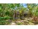 The screened-in pool is nestled within a lush backyard with beautiful landscaping at 2061 Misty Sunrise Trl, Sarasota, FL 34240