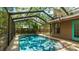 The screened-in pool offers privacy with steps for easy access and a backyard view at 2061 Misty Sunrise Trl, Sarasota, FL 34240