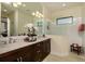 Bright bathroom features double vanity, granite counters, and large seamless glass shower at 21225 Wacissa Dr, Venice, FL 34293
