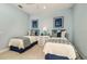 Charming bedroom features twin beds, nautical decor, and a serene color scheme at 21225 Wacissa Dr, Venice, FL 34293