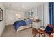 Inviting bedroom with soft blue bedding, nautical accents, and natural light at 21225 Wacissa Dr, Venice, FL 34293