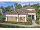 Charming single-story home boasting a tile roof, three-car garage, and lush landscaping at 21225 Wacissa Dr, Venice, FL 34293