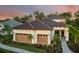 Charming one-story home with a tile roof, three-car garage, and lush landscaping at 21225 Wacissa Dr, Venice, FL 34293