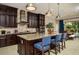 Well-appointed kitchen with an island, pendant lighting, granite countertops, and modern appliances at 21225 Wacissa Dr, Venice, FL 34293