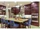 A gourmet kitchen boasts granite countertops, stainless steel appliances, and a spacious island with seating for four at 21225 Wacissa Dr, Venice, FL 34293