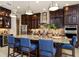 Gourmet kitchen featuring a large island, pendant lights, granite counters, and stainless appliances at 21225 Wacissa Dr, Venice, FL 34293