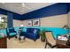 Comfortable sitting room features a blue palette, stylish furniture, and natural light at 21225 Wacissa Dr, Venice, FL 34293