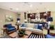 Cozy living room with a comfortable seating area, striped rug, and access to a modern kitchen and bar area at 21225 Wacissa Dr, Venice, FL 34293