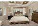 Elegant main bedroom with tray ceiling, plantation shutters, and soothing color palette at 21225 Wacissa Dr, Venice, FL 34293