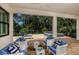 Covered patio with comfortable seating and serene views of the backyard and pool at 21225 Wacissa Dr, Venice, FL 34293