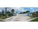 Wide angle of light blue single-story home, blue cottage, white fence, and xeriscaped yard at 21403 Glendale Ave, Port Charlotte, FL 33952