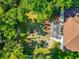A backyard with a screened-in patio, a seating area, and a fire pit surrounded by trees at 230 Fareham Dr, Venice, FL 34293