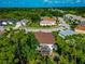 Aerial view of the home showcasing the neighborhood and lush landscaping at 230 Fareham Dr, Venice, FL 34293