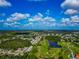 Beautiful aerial view of a residential area alongside a golf course and various ponds on a sunny day at 230 Fareham Dr, Venice, FL 34293
