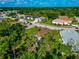 A neighborhood with tree-lined streets and well-maintained homes is captured from above at 230 Fareham Dr, Venice, FL 34293