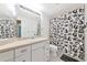 Bathroom with black and white shower curtain and vanity with sink at 230 Fareham Dr, Venice, FL 34293