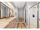 Bathroom featuring tile floors, a walk-in shower, and a large countertop space at 230 Fareham Dr, Venice, FL 34293
