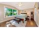 Sun-filled bedroom with large window and wood floors and furniture at 230 Fareham Dr, Venice, FL 34293