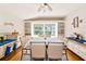 Bright dining area with built-in cabinets, a large window, and hardwood floors at 230 Fareham Dr, Venice, FL 34293