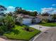 Charming single-story home featuring a well-manicured lawn, mature landscaping, and a spacious driveway at 230 Fareham Dr, Venice, FL 34293
