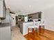 Modern kitchen with gray cabinets, stainless steel appliances, and a breakfast bar at 230 Fareham Dr, Venice, FL 34293