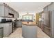 Well-equipped kitchen with stainless steel appliances, gray cabinetry and central island at 230 Fareham Dr, Venice, FL 34293