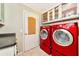 Bright laundry room features a washer, dryer, and ample storage cabinets at 230 Fareham Dr, Venice, FL 34293