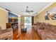 Cozy living room with hardwood floors, plush couches, and a view of the lanai at 230 Fareham Dr, Venice, FL 34293