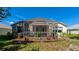 Screened-in patio is surrounded by lush landscaping for added privacy and shade at 230 Fareham Dr, Venice, FL 34293