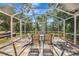 Inviting screened patio with outdoor dining set, ideal for entertaining guests at 230 Fareham Dr, Venice, FL 34293