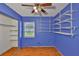 Bedroom with wood flooring, a window, shelves, closet, and a ceiling fan at 2312 Emory Ave, Bradenton, FL 34207