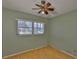 Bedroom with wood flooring, a window, and a ceiling fan at 2312 Emory Ave, Bradenton, FL 34207