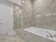 Luxurious bathroom with a soaking tub and a glass-enclosed shower at 23233 Banbury Way # 302, Venice, FL 34293