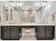 Bathroom features a double vanity with a makeup station and modern fixtures at 23233 Banbury Way # 302, Venice, FL 34293