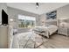 Bright bedroom with large window, ceiling fan, TV and a decorative rug at 23233 Banbury Way # 302, Venice, FL 34293