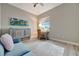 Den with a pull-out cabinet, desk, beach-themed decor, and natural light at 23233 Banbury Way # 302, Venice, FL 34293
