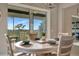 Bright dining area with scenic outdoor views, round table set, and access to the lanai at 23233 Banbury Way # 302, Venice, FL 34293