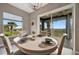 Bright dining area featuring a window with outdoor views and easy access to the outdoor balcony at 23233 Banbury Way # 302, Venice, FL 34293