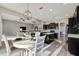 Dining area with a round table set, chandelier, and open view to the kitchen and living area at 23233 Banbury Way # 302, Venice, FL 34293