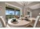 Bright dining area featuring sliding glass doors opening to a serene balcony with scenic views at 23233 Banbury Way # 302, Venice, FL 34293