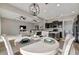 Dining area featuring a round table set, chandelier, and an open view to the kitchen and living room at 23233 Banbury Way # 302, Venice, FL 34293