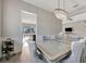 Formal dining room with chandelier, seating for six, and view to backyard at 23233 Banbury Way # 302, Venice, FL 34293
