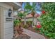 Lush landscaping and a brick walkway lead to the home's entrance at 23233 Banbury Way # 302, Venice, FL 34293