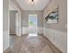 Foyer with gray walls, white trim, and wood-look flooring leading to an open living space at 23233 Banbury Way # 302, Venice, FL 34293
