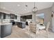 Stylish kitchen featuring dark cabinets, stainless steel appliances, and a breakfast nook at 23233 Banbury Way # 302, Venice, FL 34293