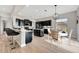 Stylish kitchen featuring dark cabinets, stainless steel appliances, a breakfast nook and island at 23233 Banbury Way # 302, Venice, FL 34293